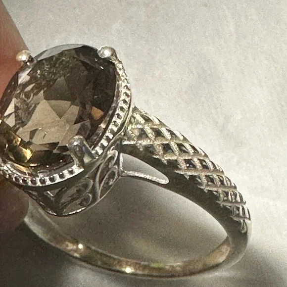 This is a sterling silver ring featuring a smoky quartz gemstone